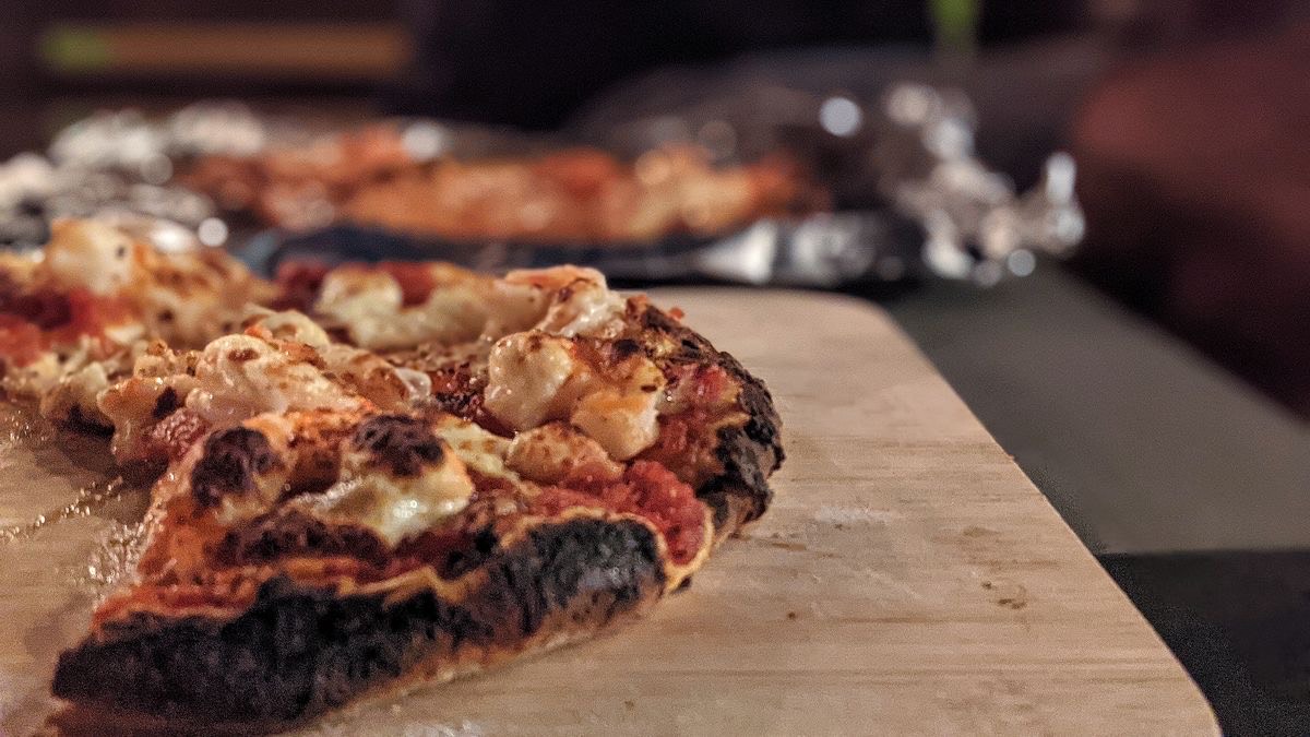 a picture of pizza on a cutting board