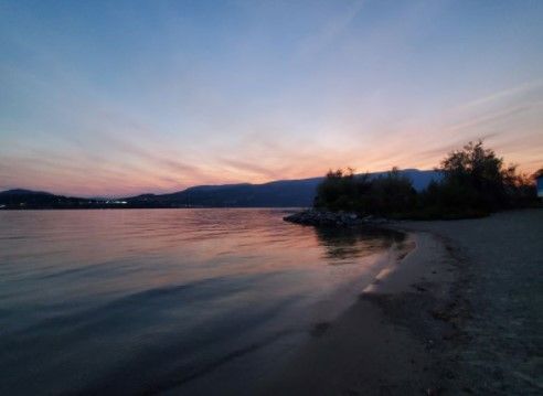 picture of a backyeard beach with a colorful sunfall